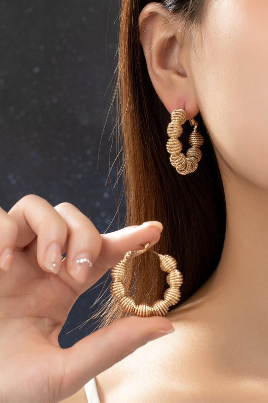 Diamond cut wavy coil hoop earrings