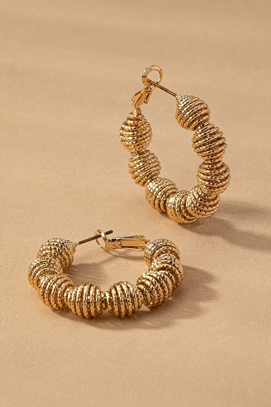 Diamond cut wavy coil hoop earrings